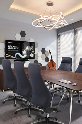 Modern conference room with dark wooden conference table and high-backed office chairs. Professional meeting space with wall-mounted display and acoustic panels.