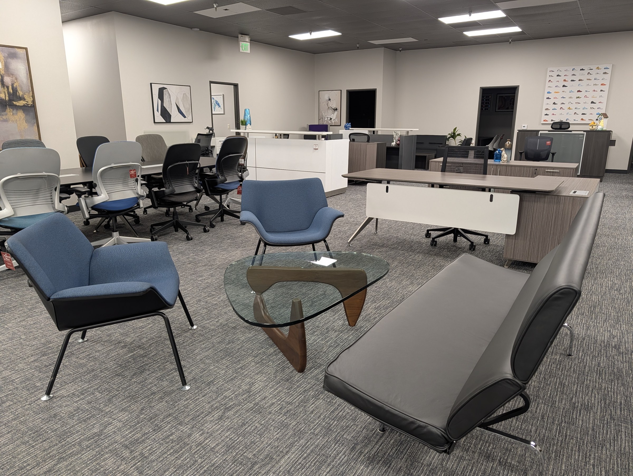 Rows of used task chairs, lounge seating and benching desks on the Irvine showroom floor